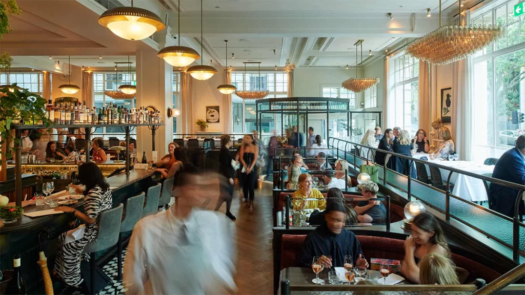 The interior of a busy restaurant full of customers mid-afternoon.