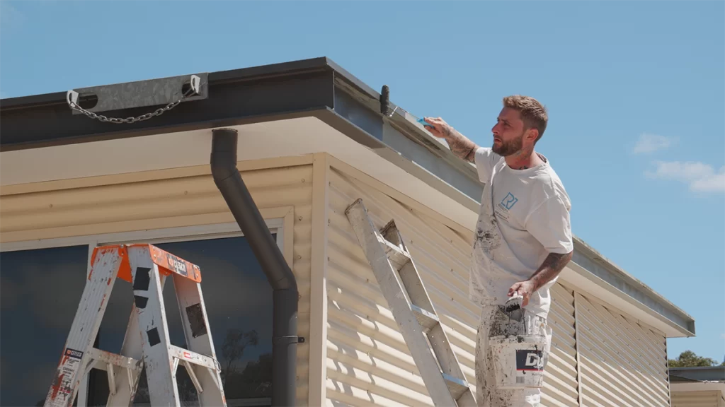 A painter from Resolute Painting working onsite on a building at Cranbourne Primary School.