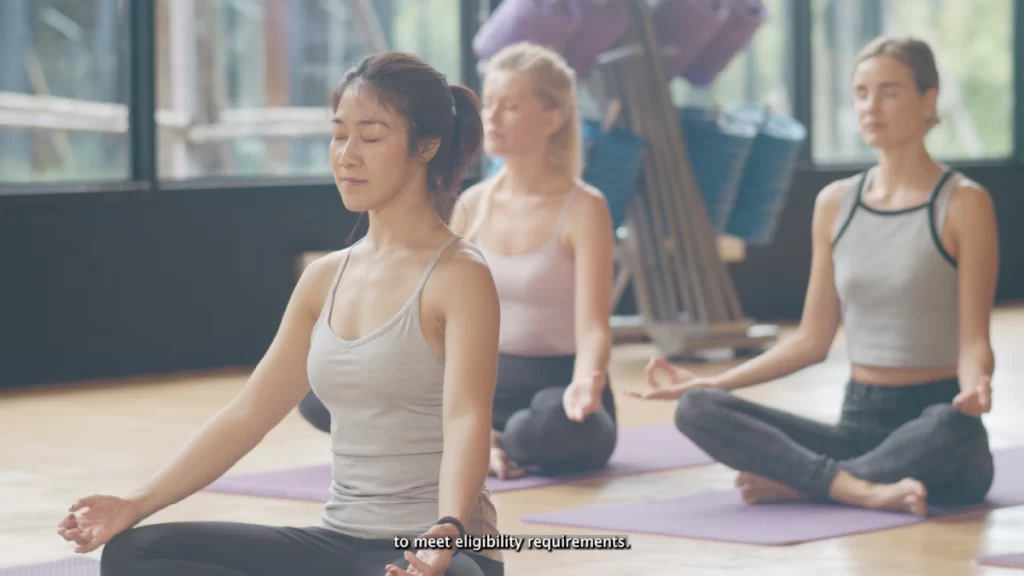 A video using closed captions, featuring 3 women performing yoga.